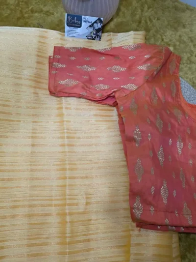 Fancy yellow semi organza saree with classic orange blouse